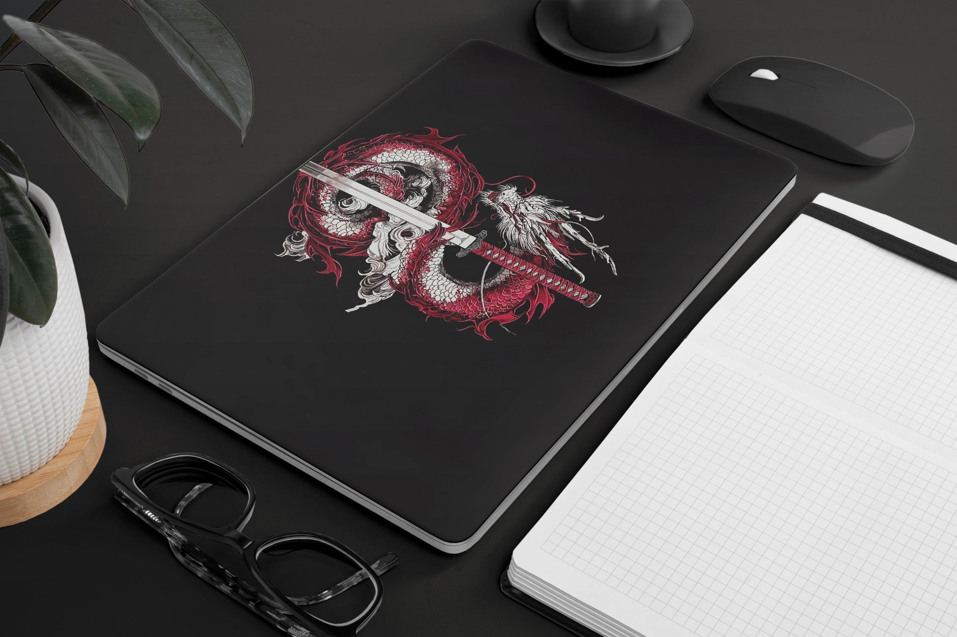 Macbook Skin - a dragon and sword design on a black background