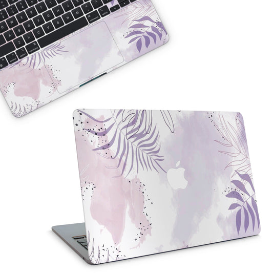 Laptop with a floral design skin on a white background