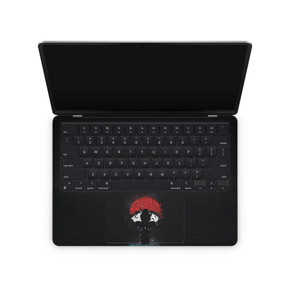 macbook skin with naruto uchiha clan logo on keyboard