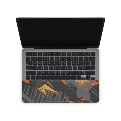 laptop skin with orange and black abstract pattern on touchpad area